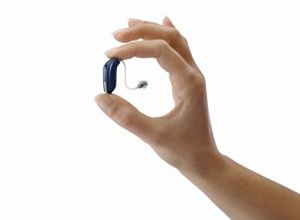 holding a hearing aid